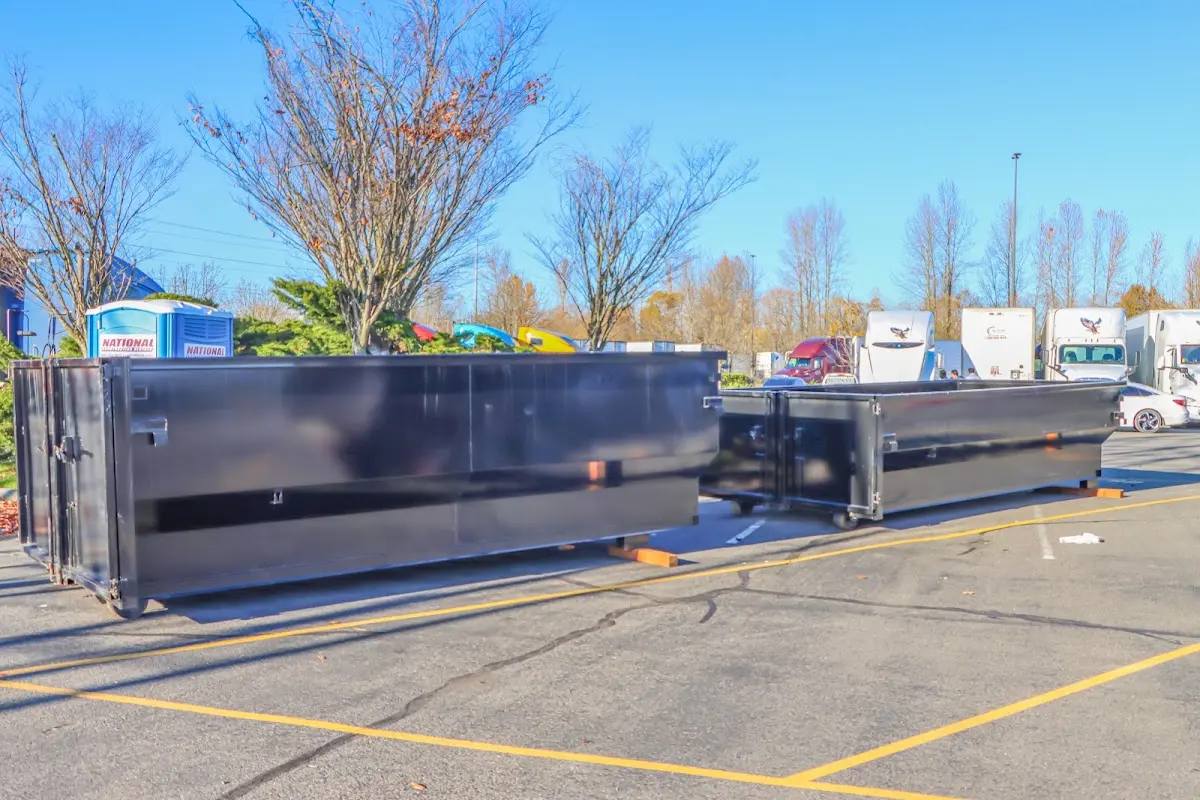 Professional dumpster rental service with roll-off container on residential driveway in Kahaluu